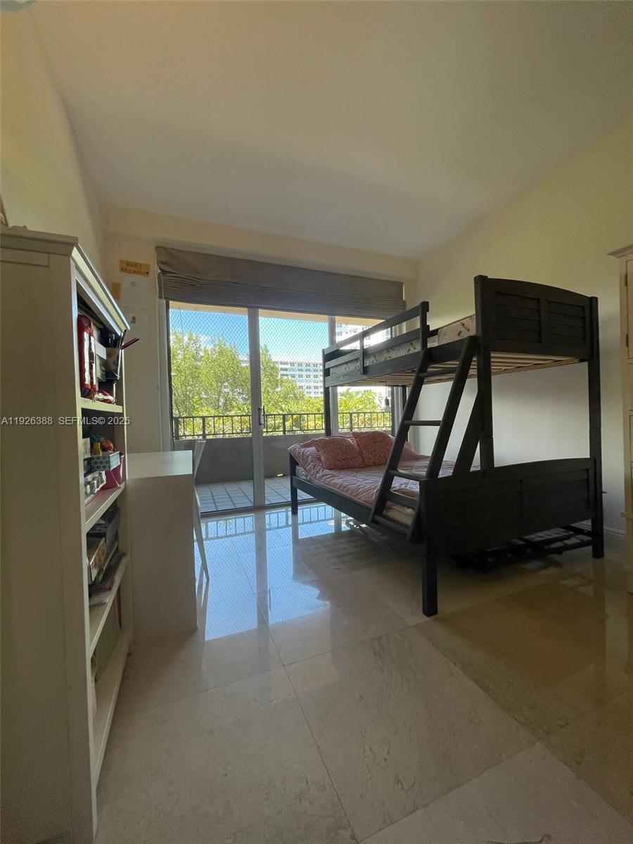 251 Crandon Boulevard, Unit 233 Key Biscayne, FL 33149 - Photo 18 of 27 a living room with furniture and a flat screen tv