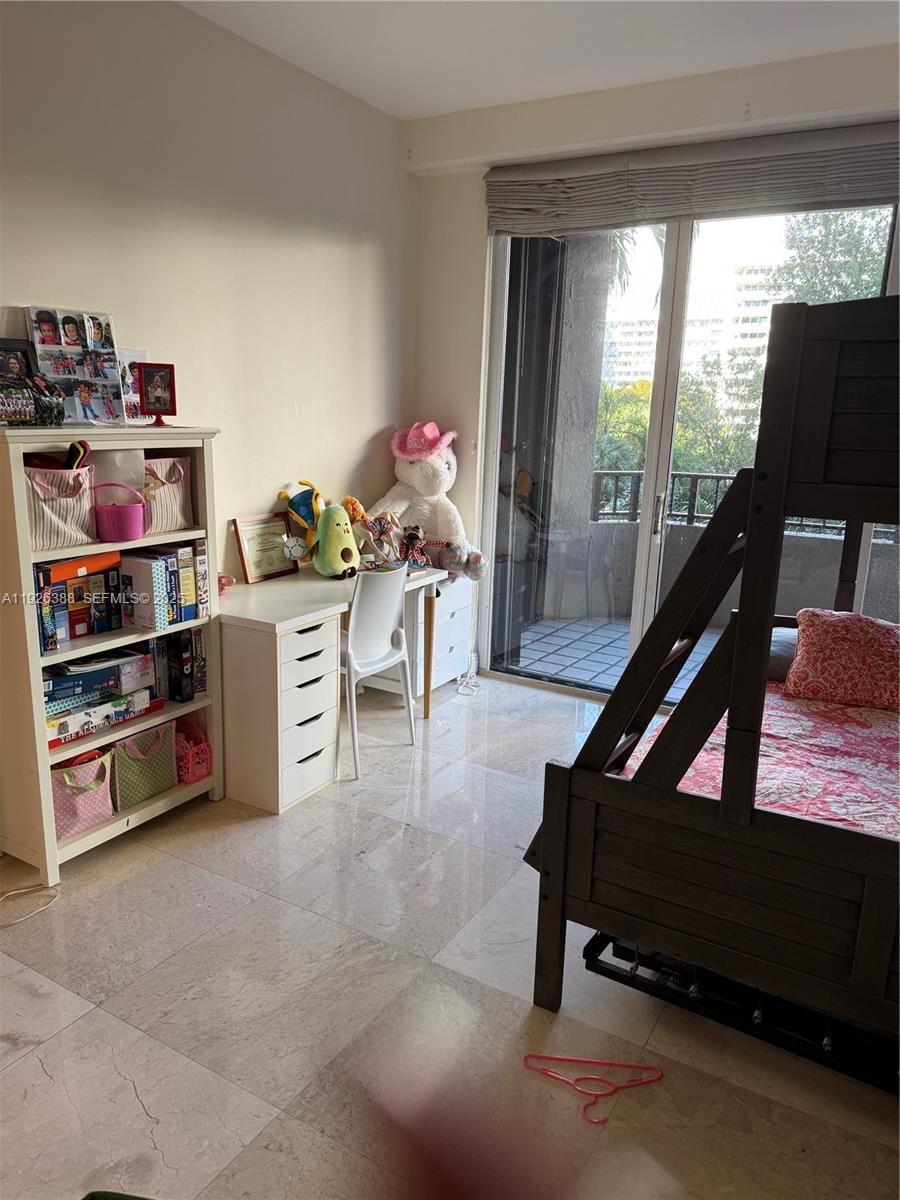 251 Crandon Boulevard, Unit 233 Key Biscayne, FL 33149 - Photo 22 of 27 a living room with furniture and a book shelf