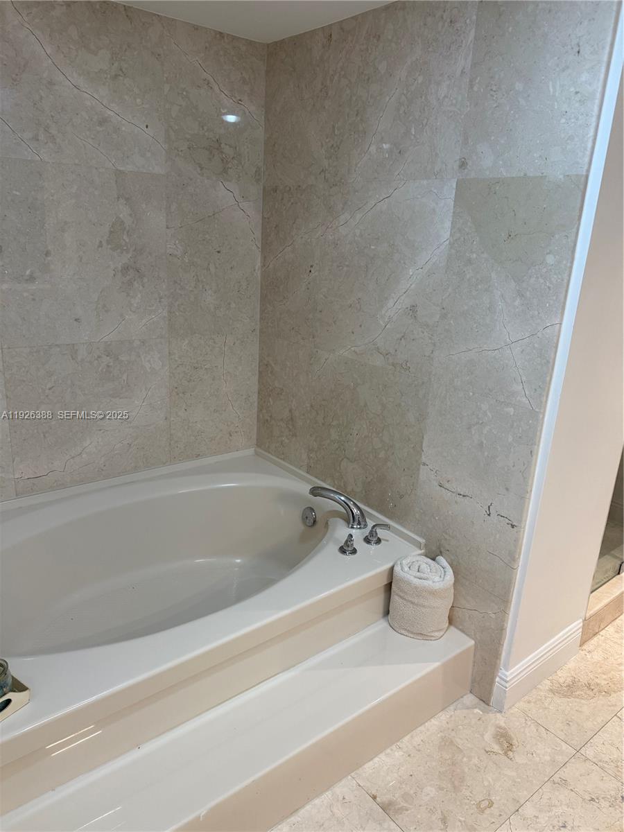 251 Crandon Boulevard, Unit 233 Key Biscayne, FL 33149 - Photo 26 of 27 a bathroom with a bathtub