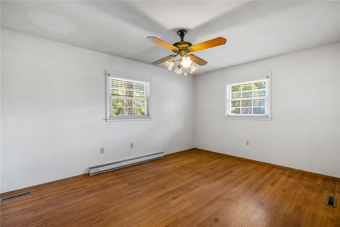 2101 Old Spring Drive Anderson, SC 29625 - Photo 14 of 36 Hardwood floors and generous natural light define this cozy bedroom space.