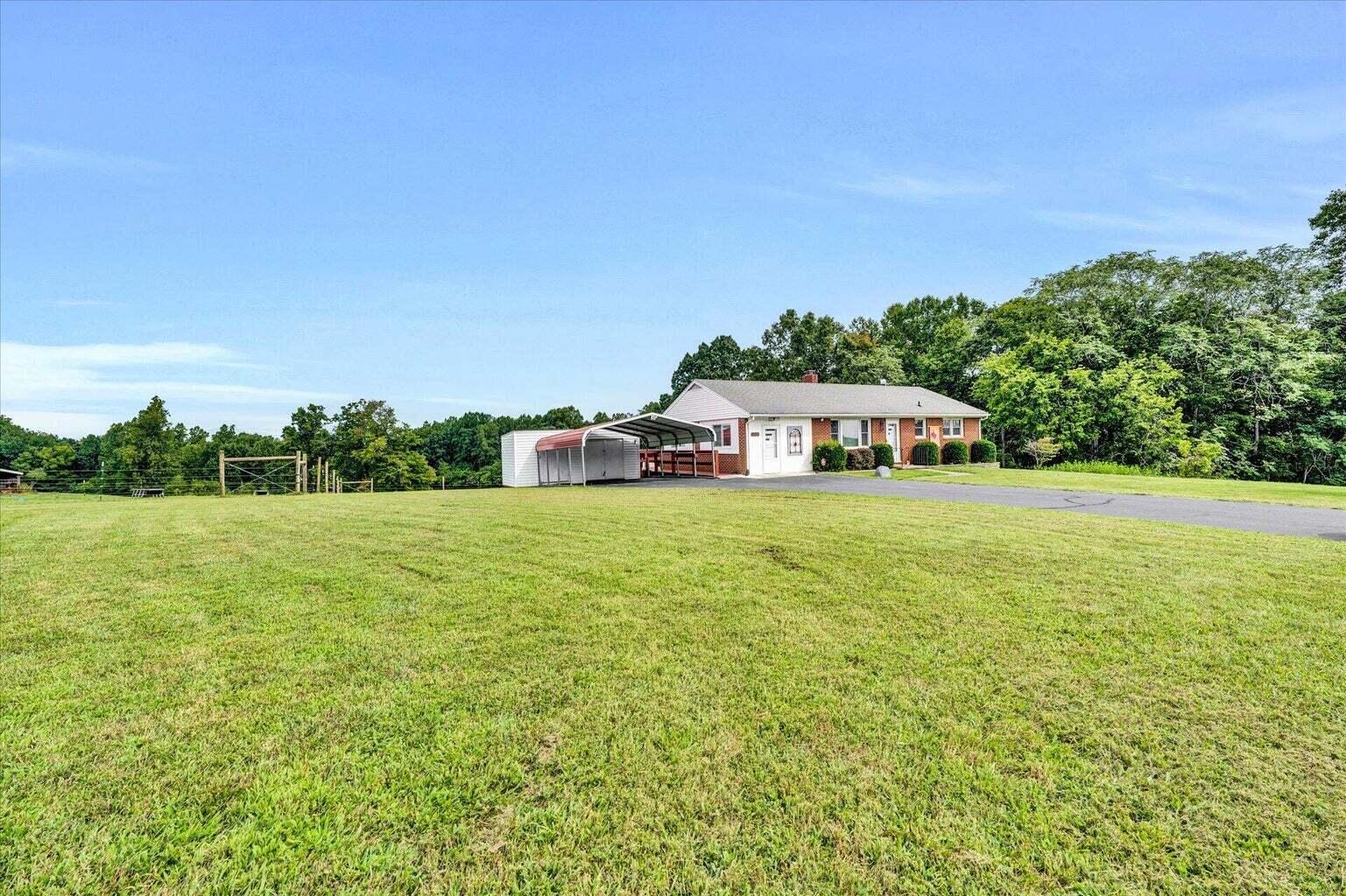 311 Moorman Road Hardy, VA 24101 - Photo 2 of 29 a yellow building with trees in the background