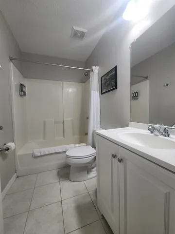a bedroom with bed and a chandelier