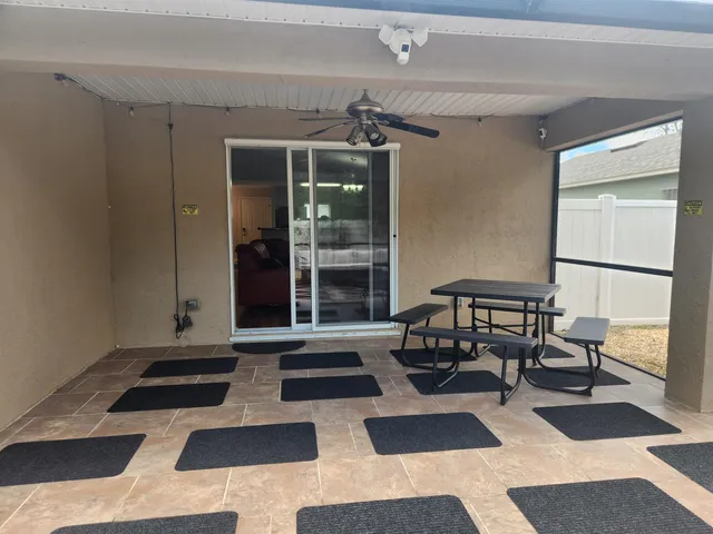 a living room with a black white checkered floor with couches in a living room