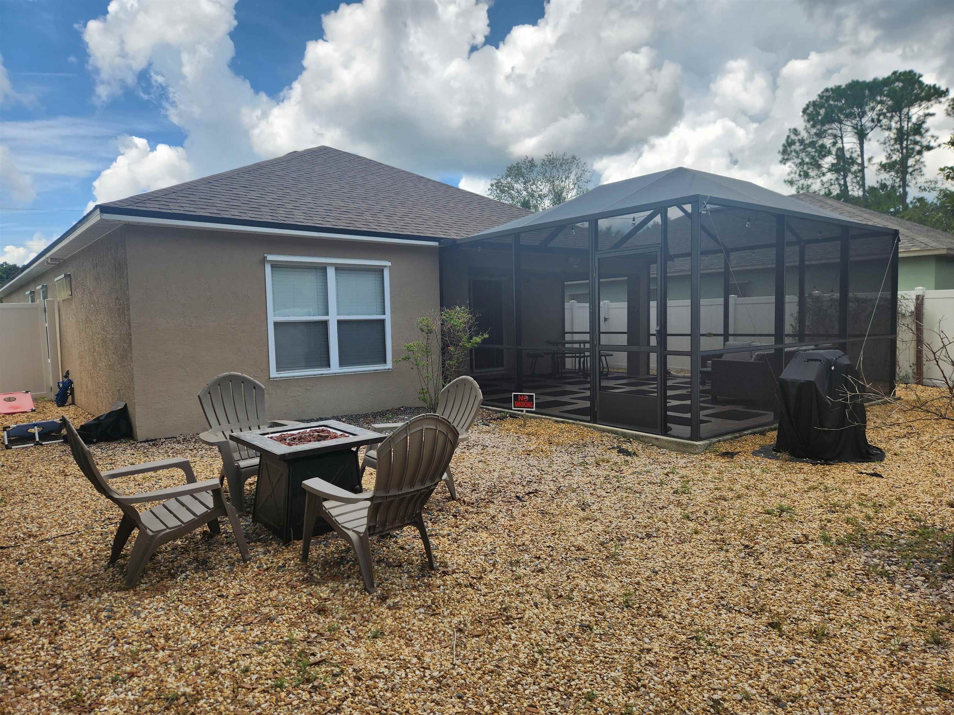 162 Stewart Street St. Augustine, FL 32084 - Photo 18 of 23 a backyard of a house with table and chairs