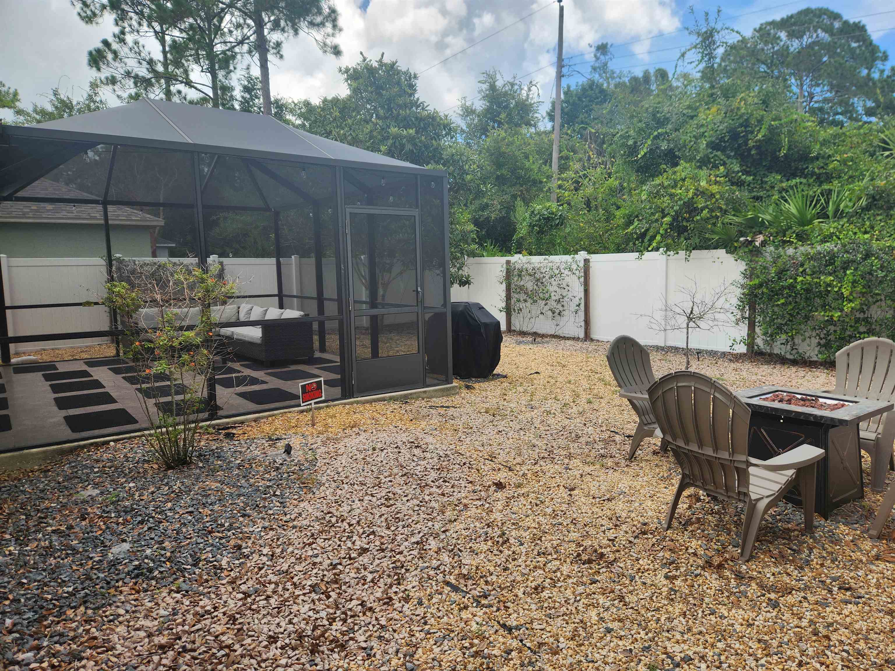 162 Stewart Street St. Augustine, FL 32084 - Photo 19 of 23 a backyard of a house with barbeque oven table and chairs