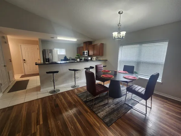 a view of a dining room with furniture and wooden floor
