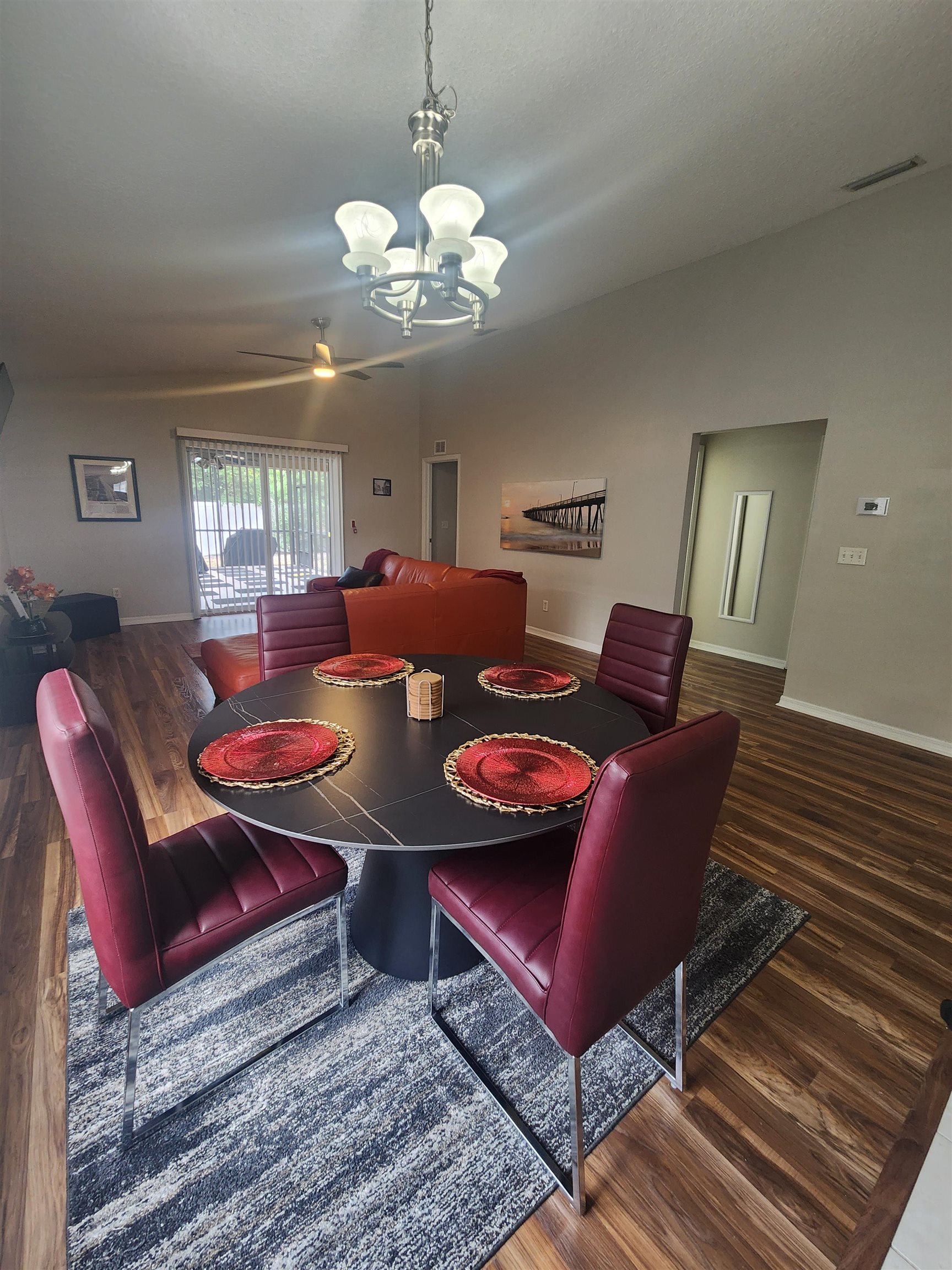 162 Stewart Street St. Augustine, FL 32084 - Photo 6 of 23 a living room with furniture a chandelier and a rug