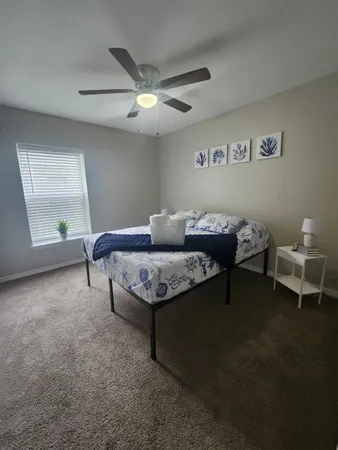 a living room with furniture a chandelier and a rug