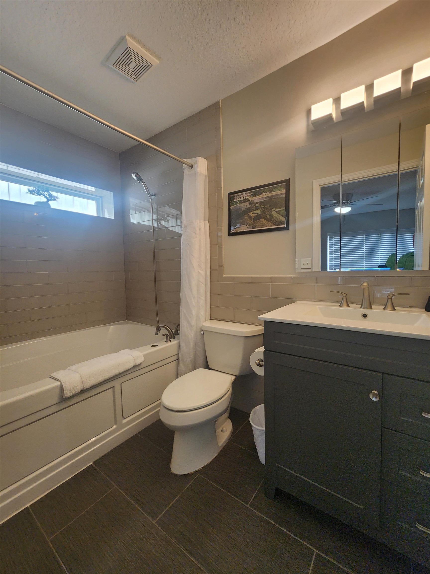 162 Stewart Street St. Augustine, FL 32084 - Photo 9 of 23 a bathroom with a sink a toilet a mirror and bathtub
