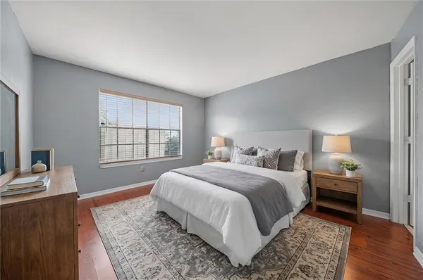 a spacious bedroom with a bed and a window