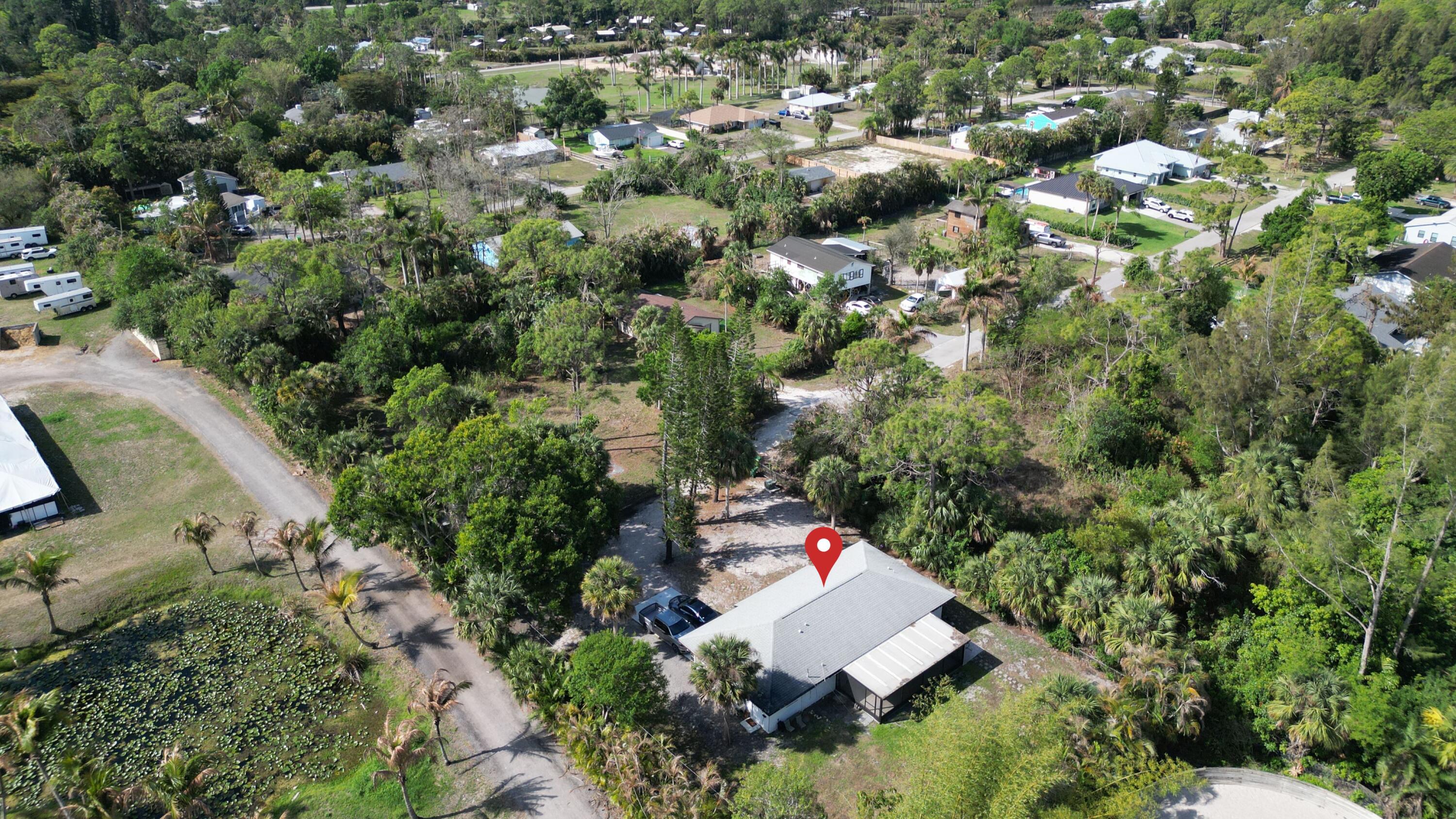 14523 Flamingo Road Loxahatchee Groves, FL 33470 - Photo 1 of 50 an aerial view of a house with a yard and outdoor seating
