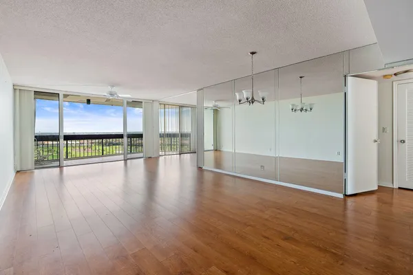 a view of a livingroom with wooden floor and a window