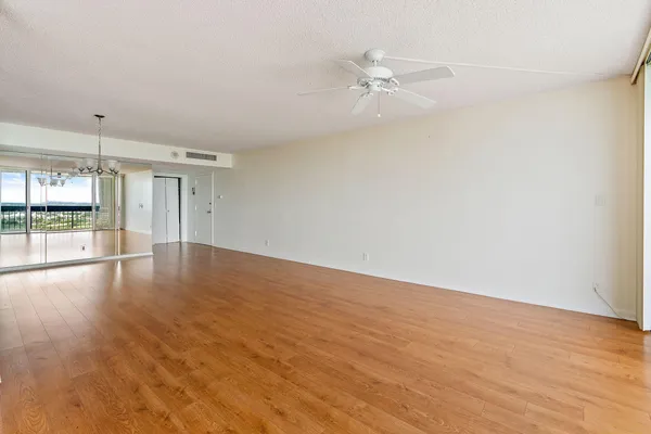 an empty room with wooden floor and door