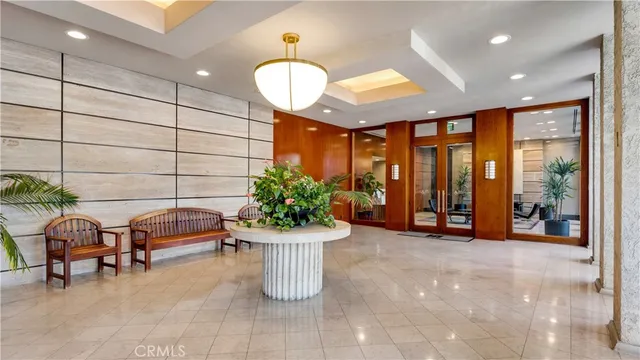 a view of entryway with a hall and chandelier