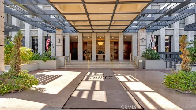 a view of a patio with a table and chairs under an umbrella with a small yard