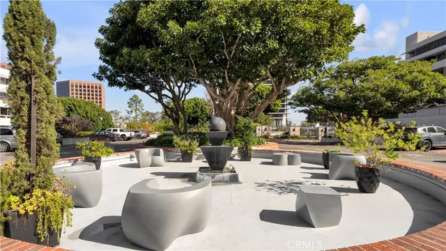 a front view of a house with a garden and trees