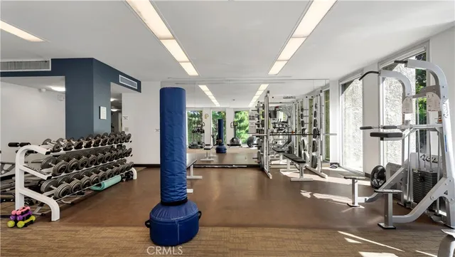 a large bedroom with furniture and large windows