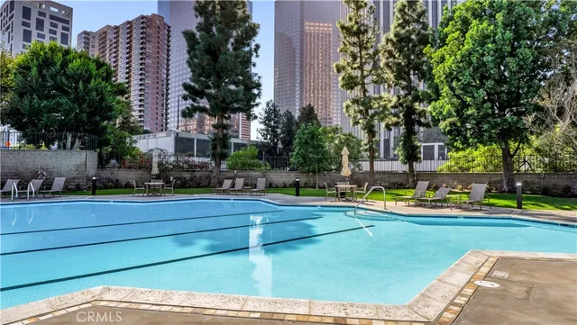 a kitchen with stainless steel appliances kitchen island granite countertop a refrigerator and a sink