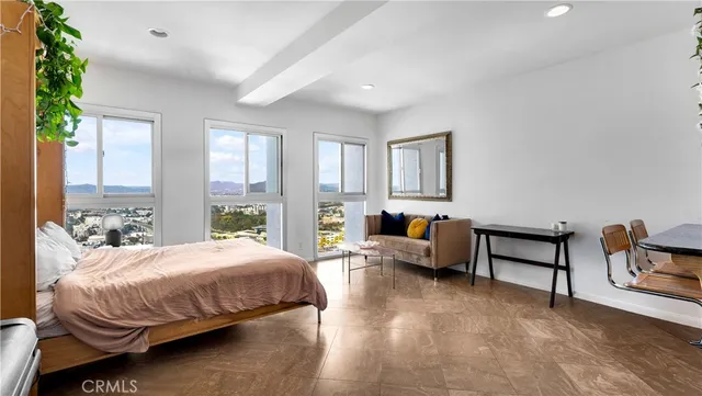 a bedroom with a bed and a couch