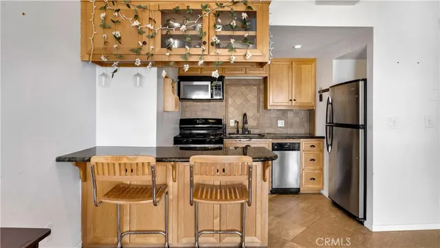 a kitchen with stainless steel appliances granite countertop a stove and a refrigerator