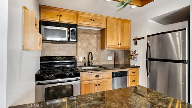 a kitchen with a refrigerator stove and sink
