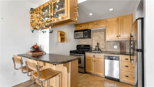 a kitchen with a stove a sink and a refrigerator
