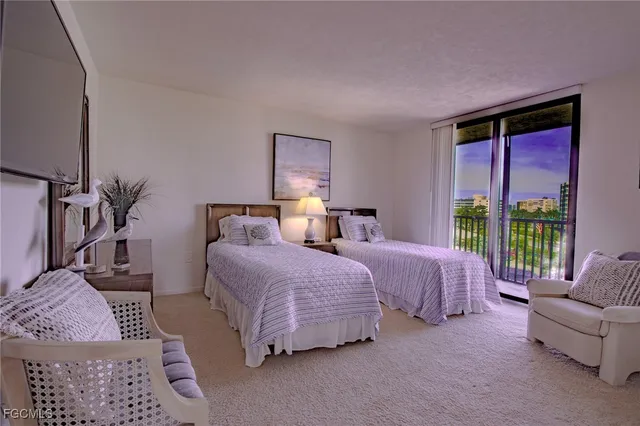 a spacious bedroom with two beds and large windows