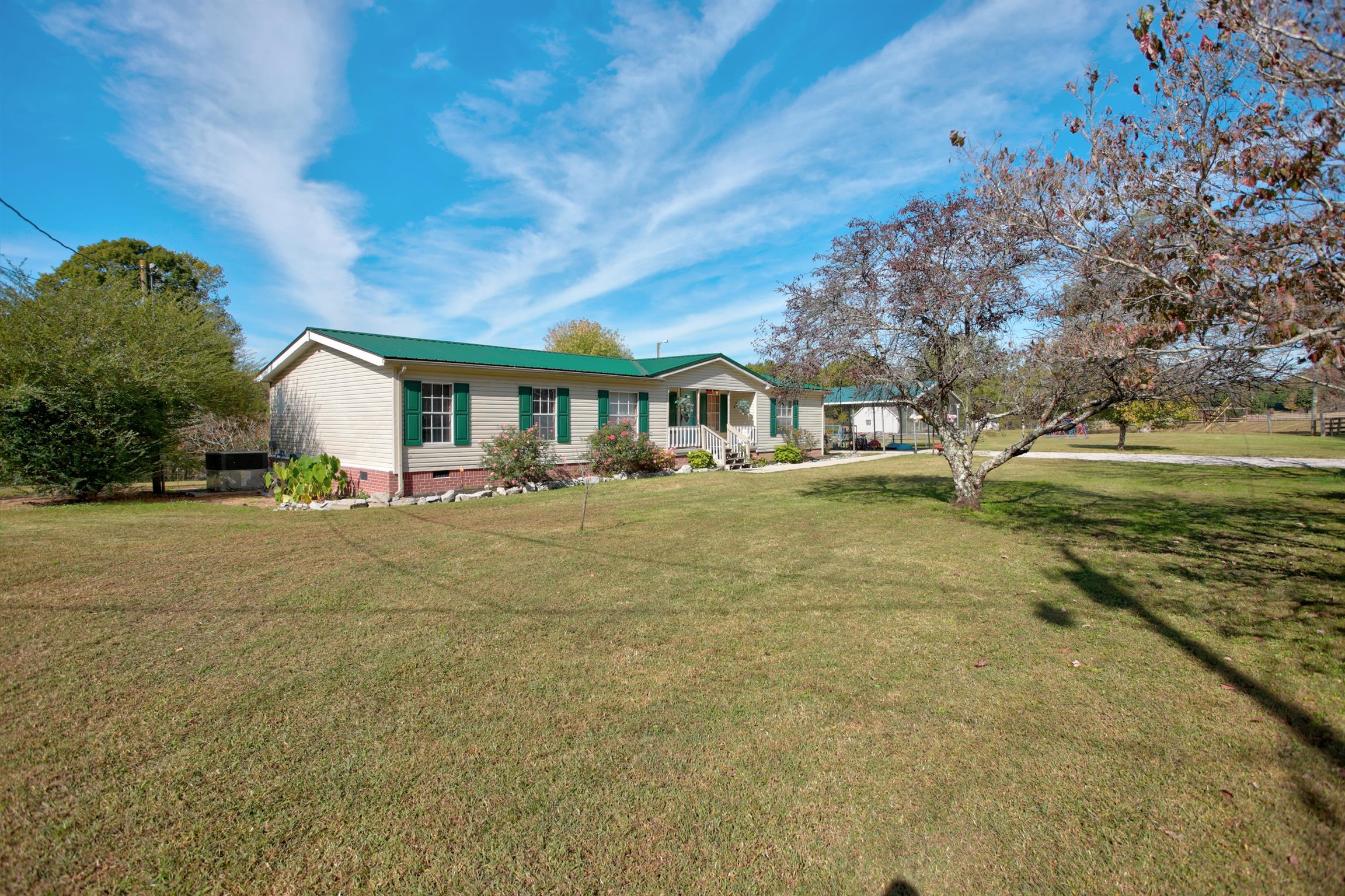 3343 Ridge Road Columbia, TN 38401 - Photo 4 of 27 a front view of a house with a garden and trees