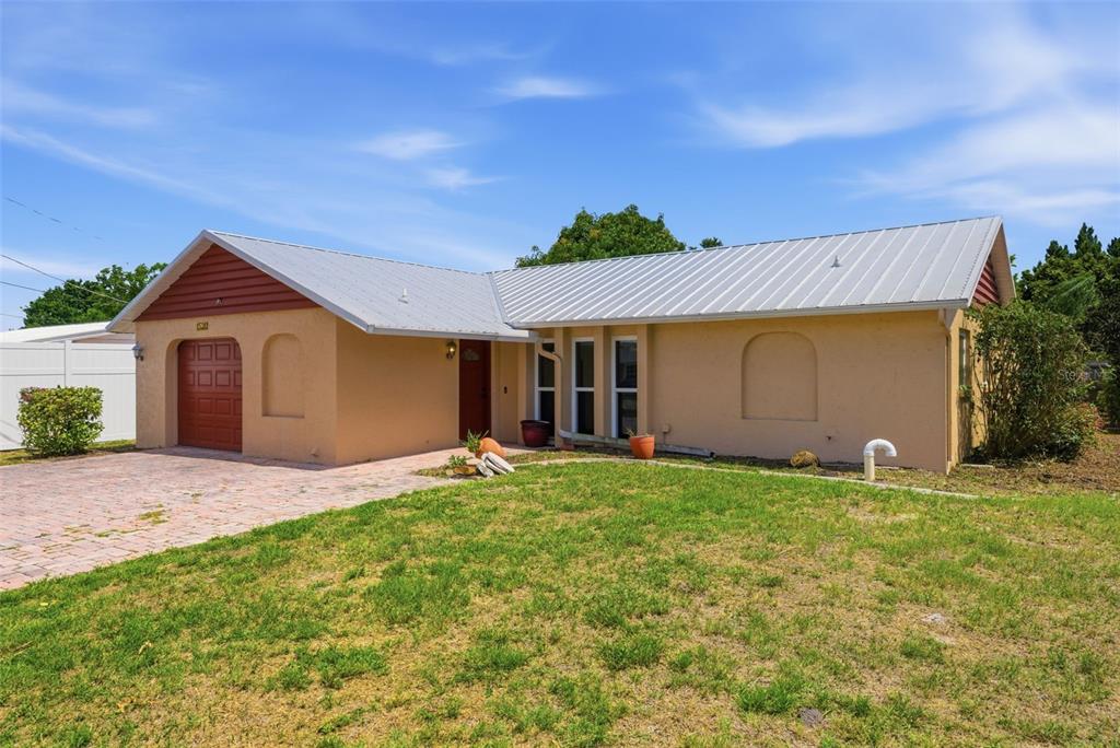 4536 Webber Street Sarasota, FL 34232 - Photo 2 of 45 a front view of a house with a garden and yard
