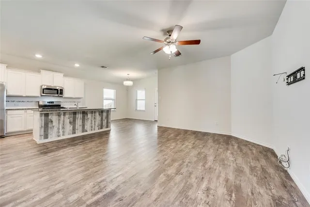 a view of kitchen with sink and wooden floor