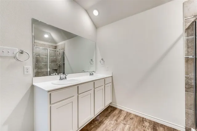 a bathroom with a glass shower door