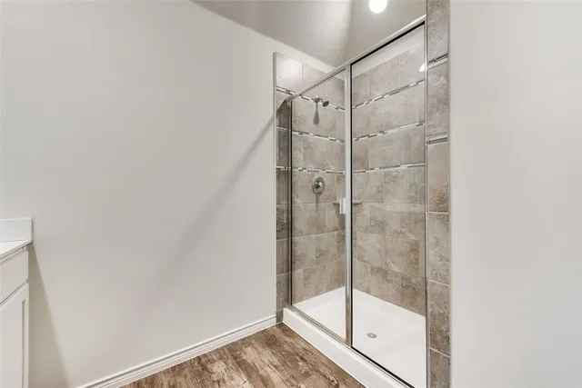 a view of a yard with wooden fence