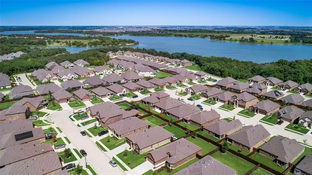 an aerial view of residential building with outdoor space and ocean view