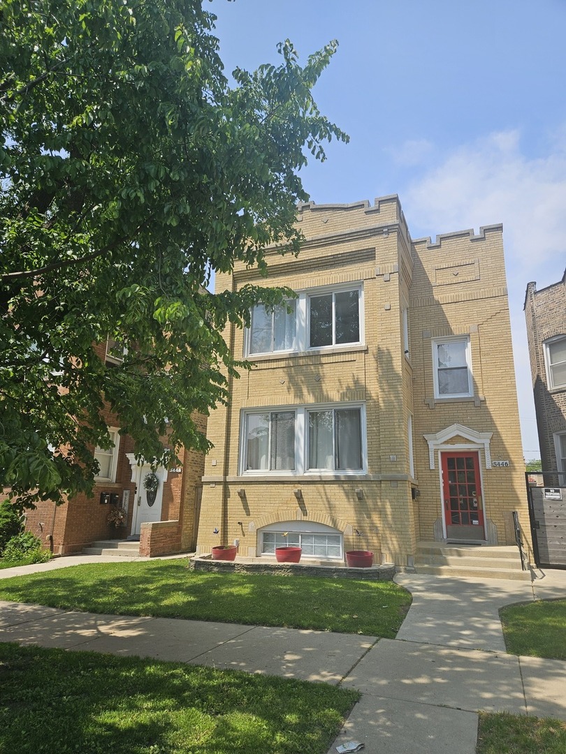 a front view of building with yard