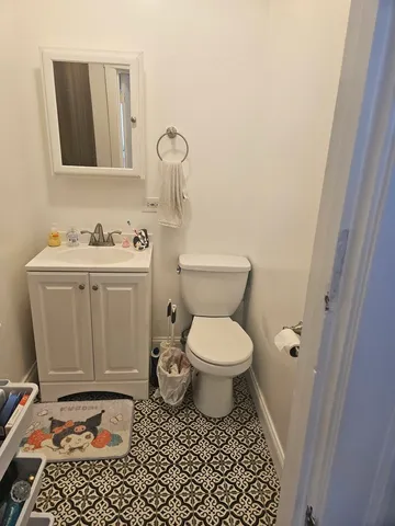 a bathroom with a toilet a sink and a window