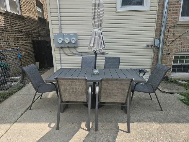 a view of a patio with table and chairs and wooden floor