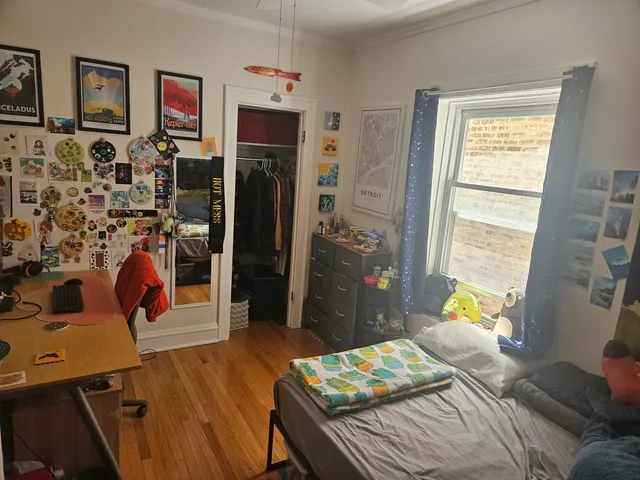 a bedroom that has a bed and a dresser in it