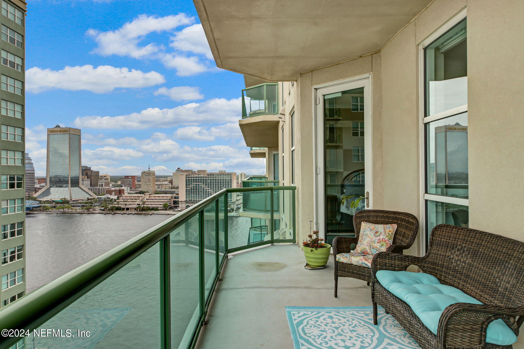 a balcony with furniture and a lake view