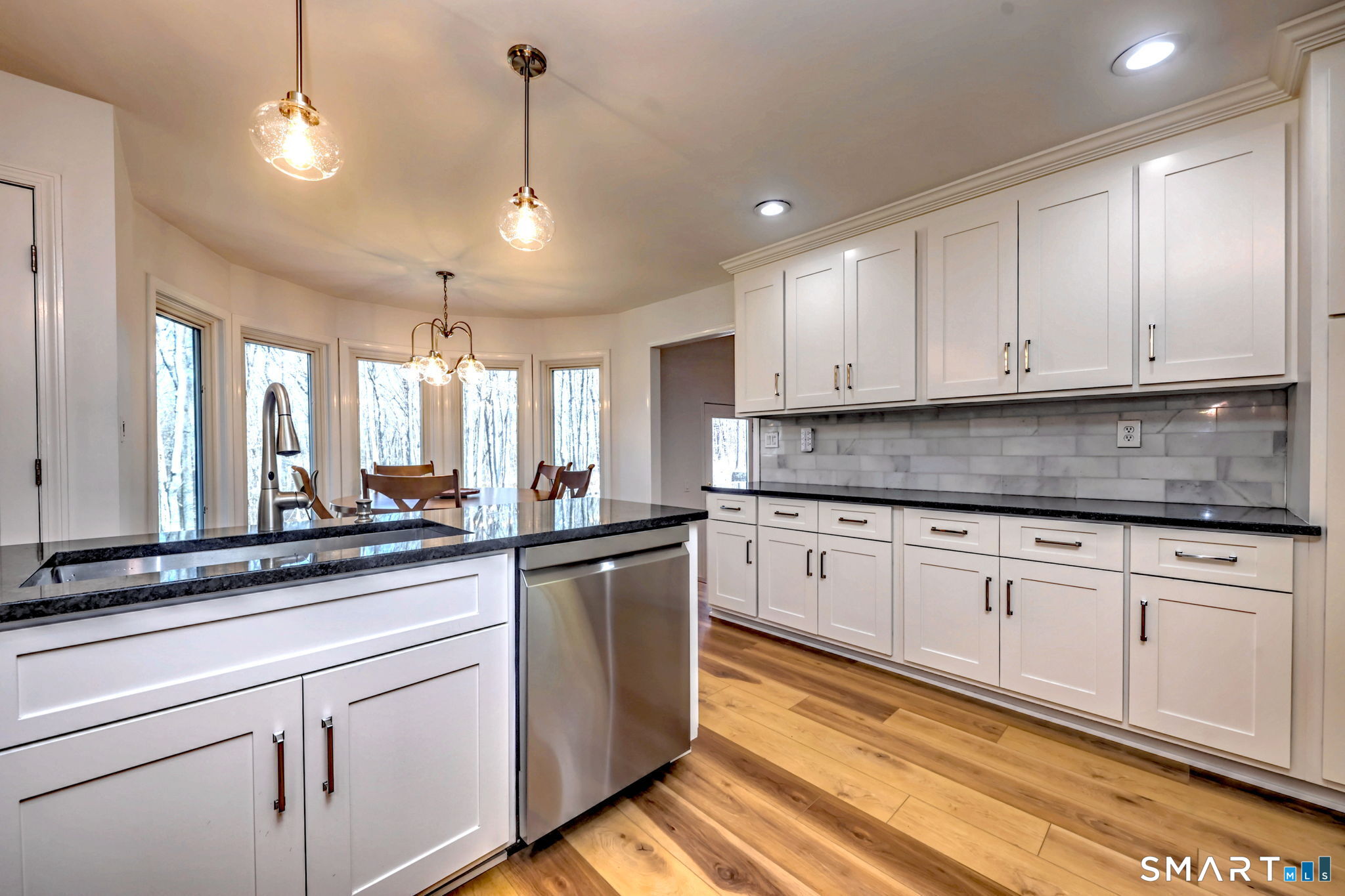 48 Nancy Drive Monroe, CT 06468 - Photo 11 of 38 a kitchen with stainless steel appliances granite countertop a sink a stove and white cabinets