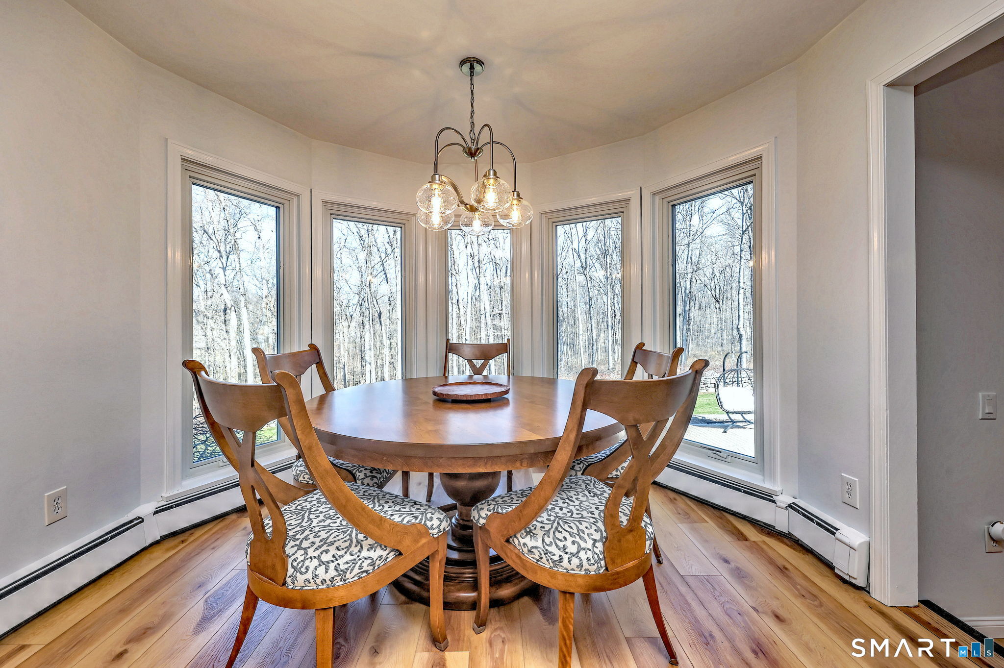 48 Nancy Drive Monroe, CT 06468 - Photo 13 of 38 a dining room with furniture a chandelier and wooden floor