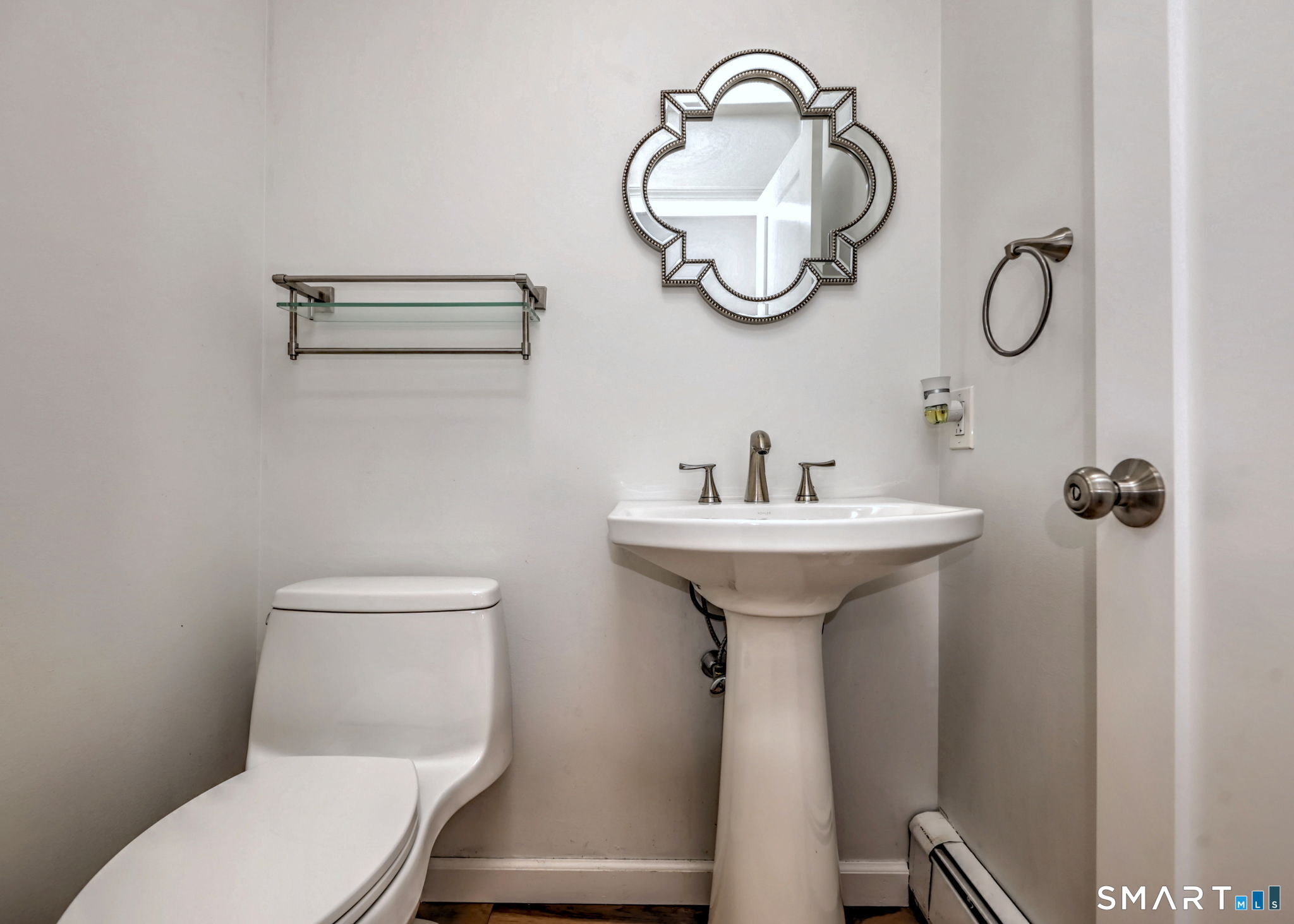 48 Nancy Drive Monroe, CT 06468 - Photo 18 of 38 a bathroom with a toilet a sink and mirror