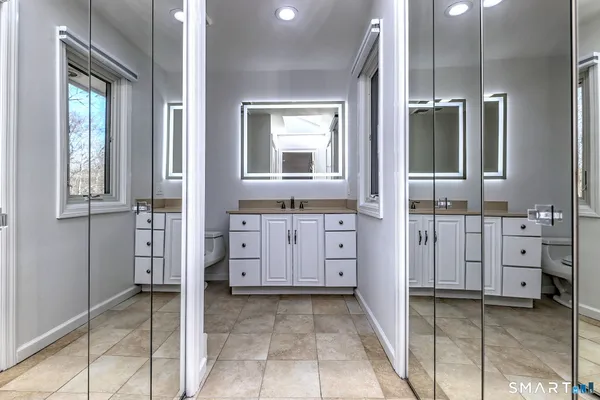 a view of a bathroom with a sink and mirror