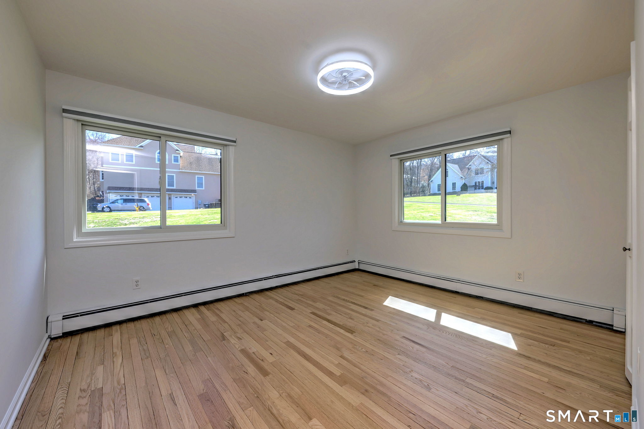 48 Nancy Drive Monroe, CT 06468 - Photo 26 of 38 an empty room with wooden floor and windows