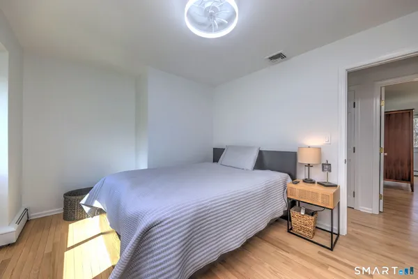 a bedroom with a bed and a table