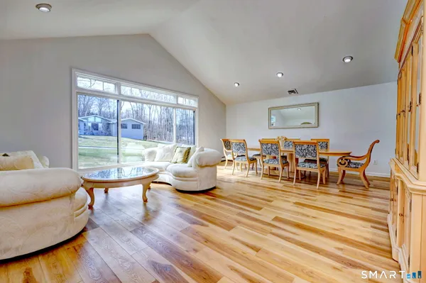 a living room with lots of furniture and a large window