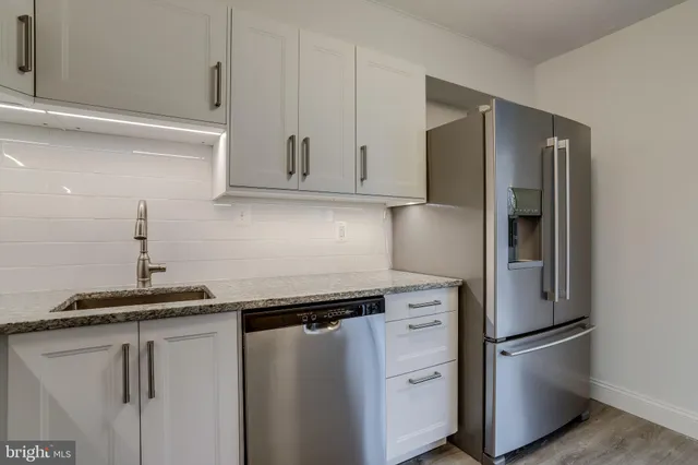 a kitchen with a refrigerator and a sink