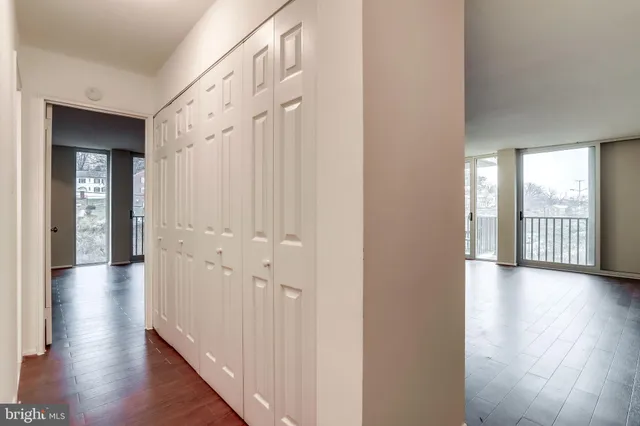 a view of a hallway with wooden floor