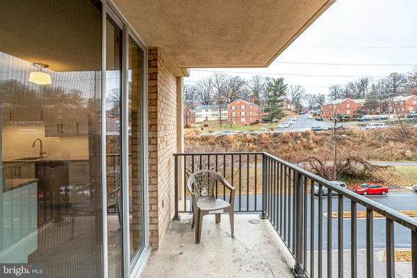 a view of a balcony with wooden floor and fence