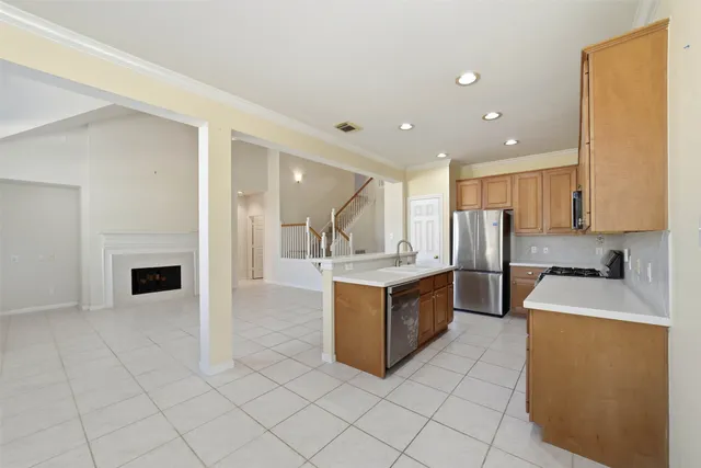 a kitchen with stainless steel appliances granite countertop a refrigerator and a stove top oven