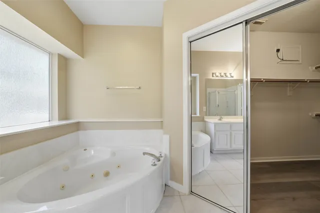 a bathroom with a bathtub and a shower